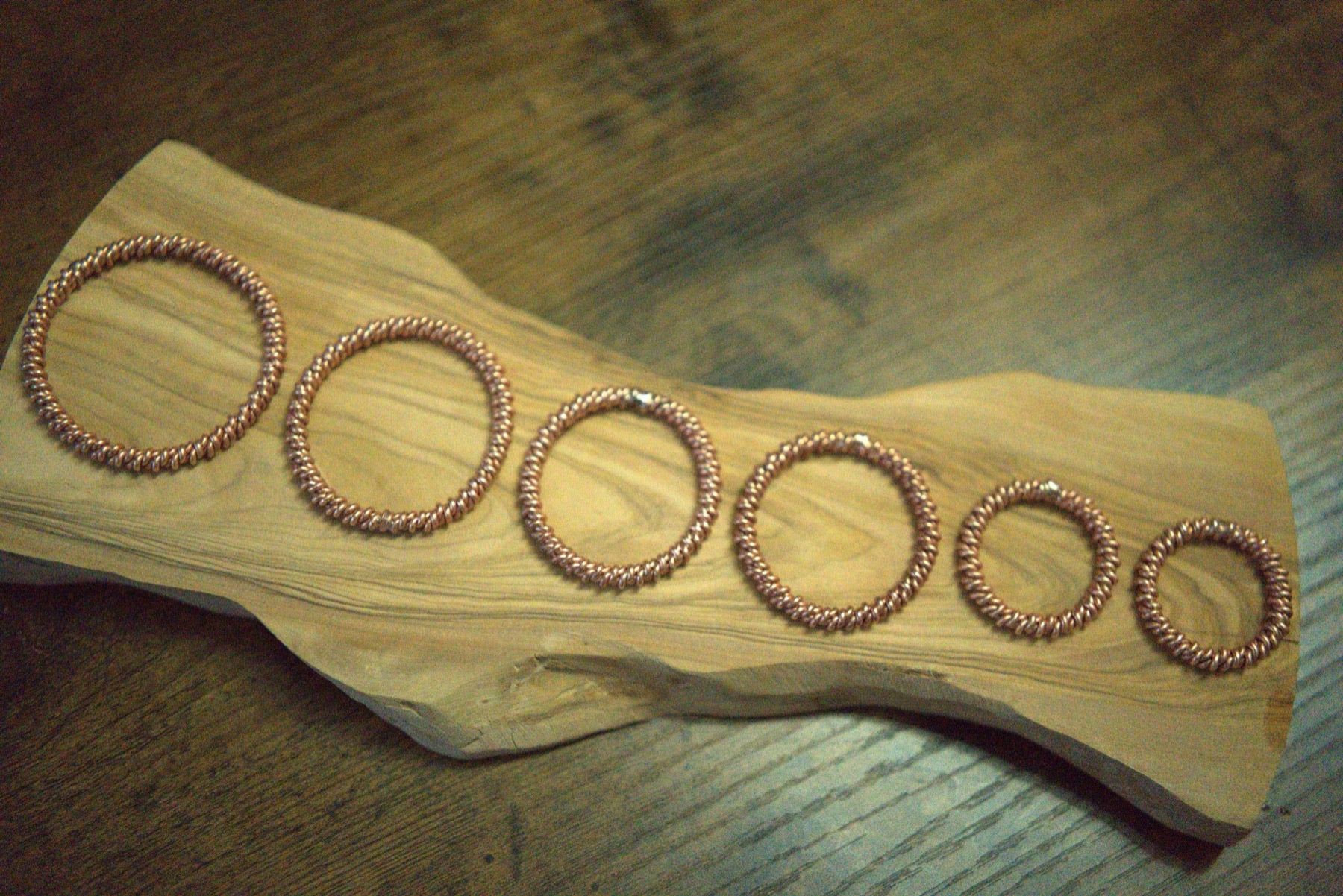 A nested run of hand-forged copper tensor rings