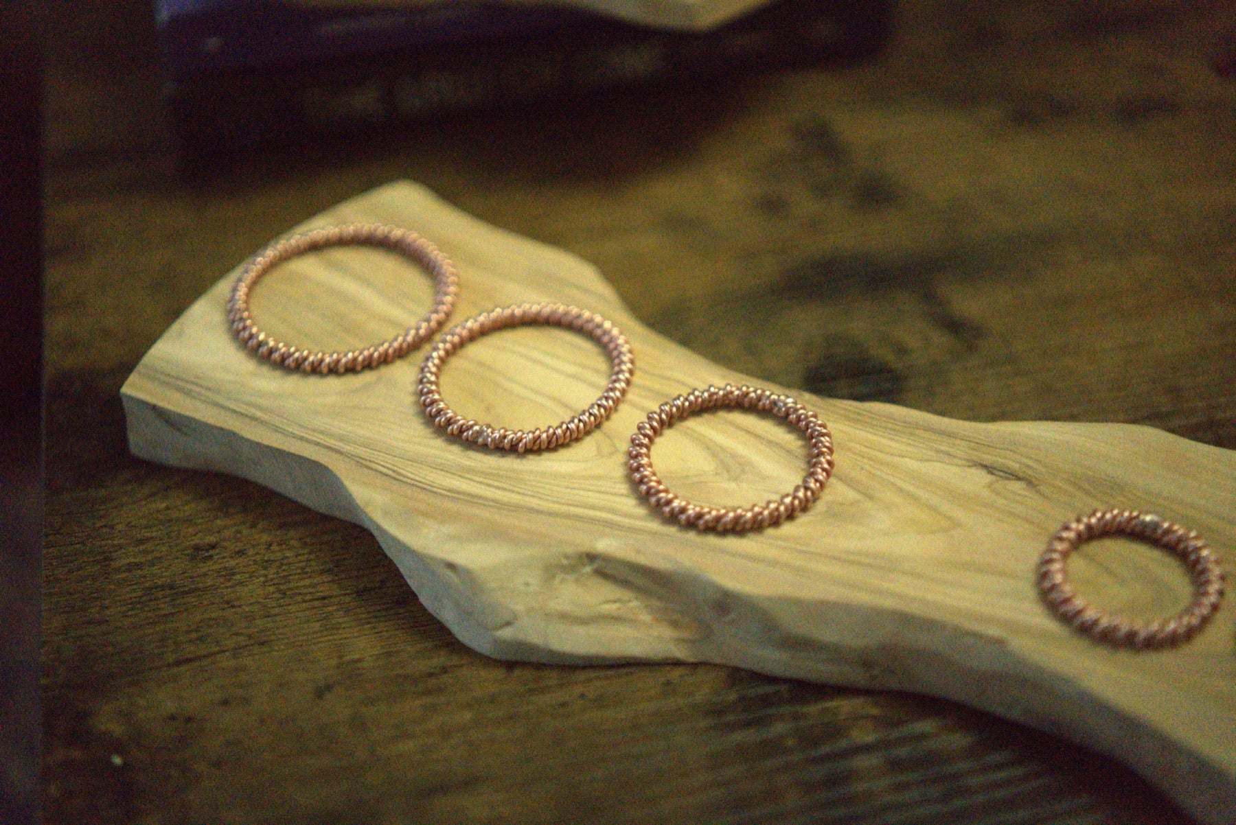 Group of double-twist copper bangles and rings