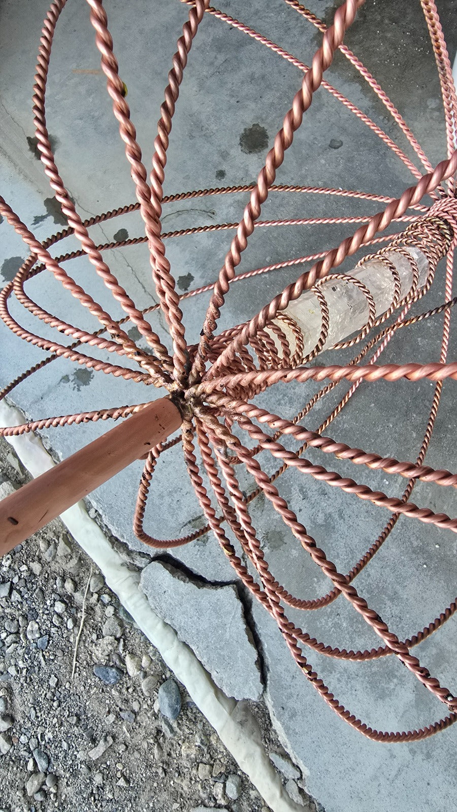 Close-up of the hand-woven copper crown and quartz crystal