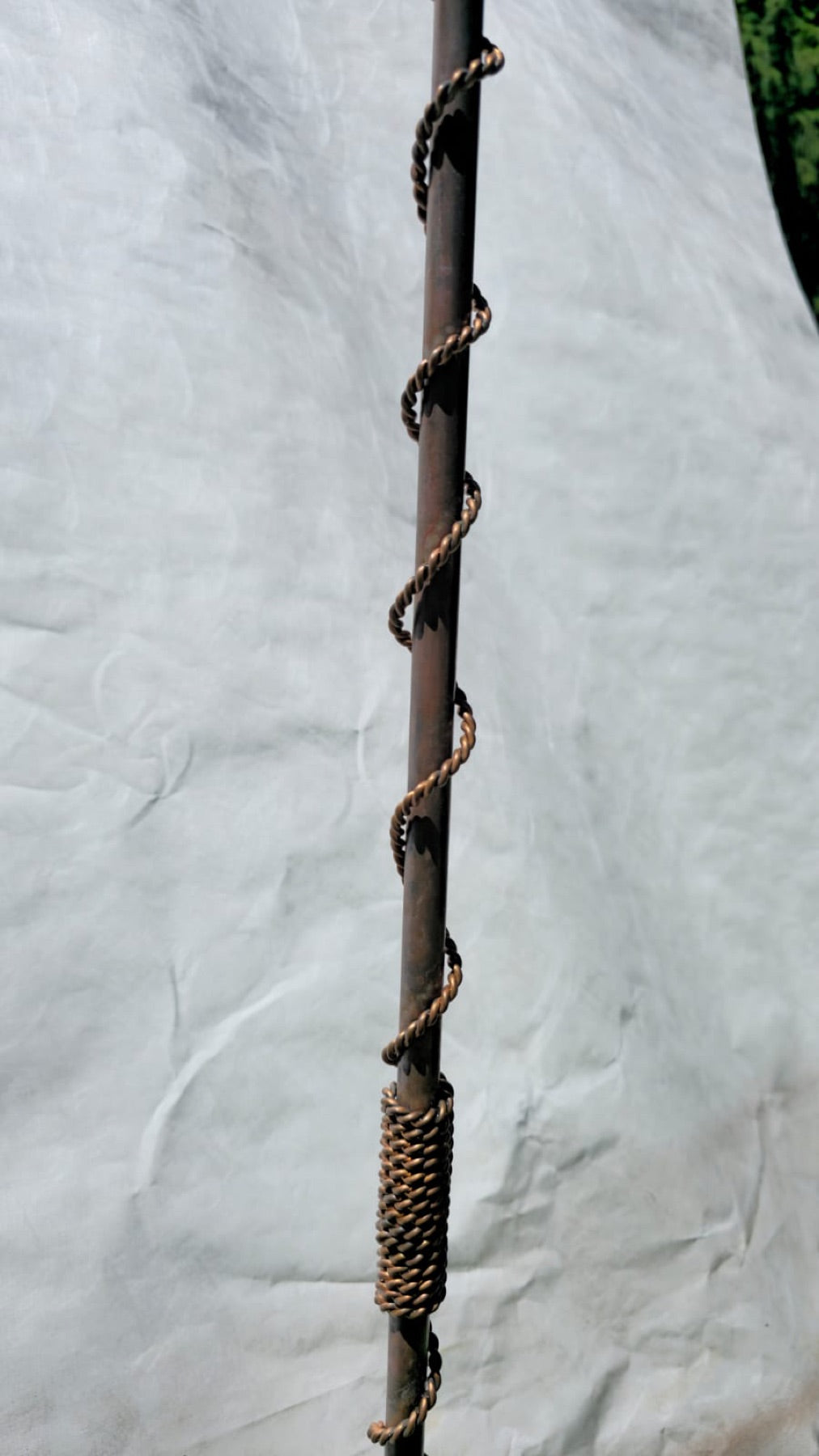 The hand-twisted copper rod resting on cloth before assembly, the survey in progress