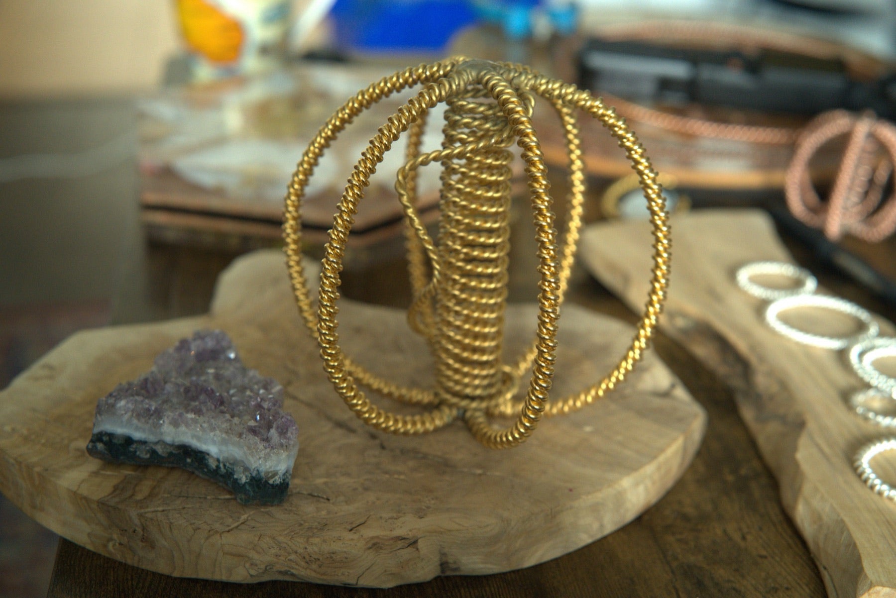 Gold-plated harmonizer beside amethyst